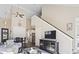 Inviting living room with a staircase, television, and an open layout to the kitchen and dining area at 6624 Lagoon Pl., Myrtle Beach, SC 29572