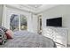 Comfortable bedroom featuring a large window with view and a dresser with a television at 6624 Lagoon Pl., Myrtle Beach, SC 29572