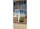 Close-up view of the exterior entry with brick stairs and a manicured shrub at 6702 Jefferson Jefferson Pl. # F2, Myrtle Beach, SC 29572