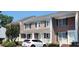 A pleasing view of the townhome exteriors, with a well-kept lawn and convenient parking spaces at 6702 Jefferson Jefferson Pl. # F2, Myrtle Beach, SC 29572