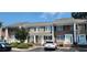 Charming townhome with a combination of tan siding and brick, a well-maintained lawn, and convenient parking at 6702 Jefferson Jefferson Pl. # F2, Myrtle Beach, SC 29572