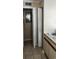Hallway showcasing built-in shelving and access to a kitchen area with a double sink at 6702 Jefferson Jefferson Pl. # F2, Myrtle Beach, SC 29572