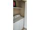 Functional laundry area with a washing machine, dryer, and shelving for storage at 6702 Jefferson Jefferson Pl. # F2, Myrtle Beach, SC 29572