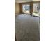 Bright and airy living room with neutral carpeting, a large window, and a glass-paneled entry door at 6702 Jefferson Jefferson Pl. # F2, Myrtle Beach, SC 29572