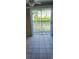 View through sliding glass doors onto a private patio space with a view of the surrounding greenery at 6702 Jefferson Jefferson Pl. # F2, Myrtle Beach, SC 29572