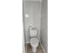 Tight view of a clean, white toilet in a small restroom with tiled walls at 6702 Jefferson Jefferson Pl. # F2, Myrtle Beach, SC 29572
