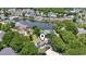 The aerial view showcases the home's serene setting with a lake and the surrounding neighborhood at 709 Triple Oak Ln., Garden City Beach, SC 29576
