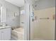 Bathroom with a tub and shower showcases a granite countertop vanity and updated fixtures for a modern touch at 709 Triple Oak Ln., Garden City Beach, SC 29576