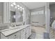 Bathroom features a soaking tub with granite surround, a vanity with granite countertop, and soft lighting at 709 Triple Oak Ln., Garden City Beach, SC 29576