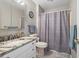 The bathroom showcases a granite countertop on the vanity, and a shower/tub combo with a patterned shower curtain at 709 Triple Oak Ln., Garden City Beach, SC 29576