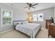 Comfortable bedroom with natural light, a ceiling fan, plush carpet, and charming decor at 709 Triple Oak Ln., Garden City Beach, SC 29576