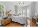 Inviting bedroom with hardwood floors, neutral tones, and a bay window seating area at 709 Triple Oak Ln., Garden City Beach, SC 29576