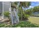 Exterior stairs leading to the elevated beach house, showcasing tropical landscaping at 709 Triple Oak Ln., Garden City Beach, SC 29576