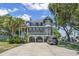 Stunning elevated home boasts abundant windows, charming porch, and convenient covered parking at 709 Triple Oak Ln., Garden City Beach, SC 29576