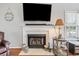 Cozy fireplace with marble surround, a TV, and decorative items, enhancing the living space at 709 Triple Oak Ln., Garden City Beach, SC 29576