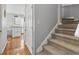 Hallway with carpeted stairs leading to a view of the kitchen, showcasing the home's layout at 709 Triple Oak Ln., Garden City Beach, SC 29576