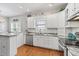 Bright kitchen features granite countertops, stainless steel appliances, and white cabinetry for a clean, modern aesthetic at 709 Triple Oak Ln., Garden City Beach, SC 29576