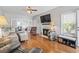Bright living room showcasing hardwood floors, fireplace, neutral tones, and comfortable seating at 709 Triple Oak Ln., Garden City Beach, SC 29576
