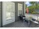Inviting porch seating area with comfortable chairs, a glass-paneled door, and charming decor at 709 Triple Oak Ln., Garden City Beach, SC 29576