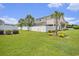 Spacious backyard with lush green grass, mature trees, and a white picket fence at 800 Monarch Dr. # 49, Myrtle Beach, SC 29588