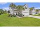 Inviting home exterior with a well-maintained lawn, mature palm trees, and a two-car attached garage at 800 Monarch Dr. # 49, Myrtle Beach, SC 29588
