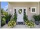 Close-up of the front door showing decorative plants, flowers, and a welcome mat at 800 Monarch Dr. # 49, Myrtle Beach, SC 29588