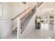 Elegant staircase with decorative iron railings leading to the upper level, next to a plant at 800 Monarch Dr. # 49, Myrtle Beach, SC 29588