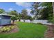 This backyard has a manicured lawn with garden beds and a white fence, creating a tranquil outdoor space at 804 47Th Ave. N, Myrtle Beach, SC 29577