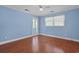 Bedroom with wood floors, ceiling fan, and natural light from two windows, creating a bright and inviting space at 804 47Th Ave. N, Myrtle Beach, SC 29577