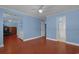 Spacious bedroom with wood floors, ceiling fan, and access to a bathroom, creating a comfortable retreat at 804 47Th Ave. N, Myrtle Beach, SC 29577