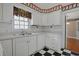 Well-lit kitchen featuring white cabinets and an adjacent dining area at 804 47Th Ave. N, Myrtle Beach, SC 29577