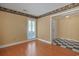 Bright room with hardwood floors and natural light from the louvered window with a black and white tiled entryway at 804 47Th Ave. N, Myrtle Beach, SC 29577