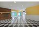 Open living room featuring a brick fireplace and a black and white checkered floor at 804 47Th Ave. N, Myrtle Beach, SC 29577