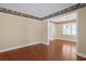 Open-concept living room with hardwood floors and a doorway leading to another room with louvered windows at 804 47Th Ave. N, Myrtle Beach, SC 29577