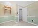Room featuring an open doorway, paneled walls, and a wall-mounted shelving unit at 804 47Th Ave. N, Myrtle Beach, SC 29577