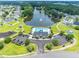 Aerial view of a community pool and clubhouse surrounded by lush landscaping, parking, and a playground at 805 Cherry Bark Ct., Myrtle Beach, SC 29579