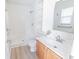 Bright bathroom with white shower, built in shelves, and light wood cabinet with modern hardware at 805 Cherry Bark Ct., Myrtle Beach, SC 29579