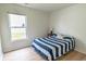 Cozy bedroom with bright window and striped comforter offers comfortable living space at 805 Cherry Bark Ct., Myrtle Beach, SC 29579