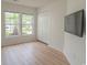 Bright bedroom featuring a closet, two windows, and sleek, modern flooring at 805 Cherry Bark Ct., Myrtle Beach, SC 29579