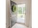 Inviting entryway with a 'Welcome' adorned door, a security screen, and a view of the well-maintained front yard at 805 Cherry Bark Ct., Myrtle Beach, SC 29579