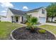 Charming home featuring lush landscaping with palm trees, a well-manicured lawn, and an attached garage at 805 Cherry Bark Ct., Myrtle Beach, SC 29579