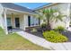 Charming home featuring lush landscaping with palm trees, a welcoming front porch, and a walkway to the entrance at 805 Cherry Bark Ct., Myrtle Beach, SC 29579