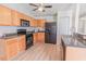Eat-in kitchen features wood cabinets, black appliances, and grey countertops at 805 Cherry Bark Ct., Myrtle Beach, SC 29579