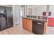 Features an eat-in kitchen with black appliances, wood cabinets and modern floors at 805 Cherry Bark Ct., Myrtle Beach, SC 29579