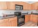 Charming kitchen featuring sleek black appliances, wood cabinets and countertops at 805 Cherry Bark Ct., Myrtle Beach, SC 29579
