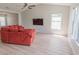 Bright, cozy living room featuring new flooring, ample natural light, and a comfortable sofa, ideal for relaxation at 805 Cherry Bark Ct., Myrtle Beach, SC 29579