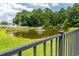 Scenic pond view with fountain and lush greenery, enhanced by a charming fence in a peaceful neighborhood setting at 805 Cherry Bark Ct., Myrtle Beach, SC 29579