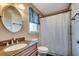 Bathroom with an oval mirror, granite vanity and a shower with a curtain at 808 Myrtle Ct. # 808, North Myrtle Beach, SC 29582