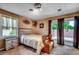 Bedroom featuring a bed with a wooden headboard and access to the outdoor deck at 808 Myrtle Ct. # 808, North Myrtle Beach, SC 29582