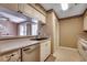 Bright kitchen with white cabinets, stainless steel dishwasher, and view into the living room at 808 Myrtle Ct. # 808, North Myrtle Beach, SC 29582